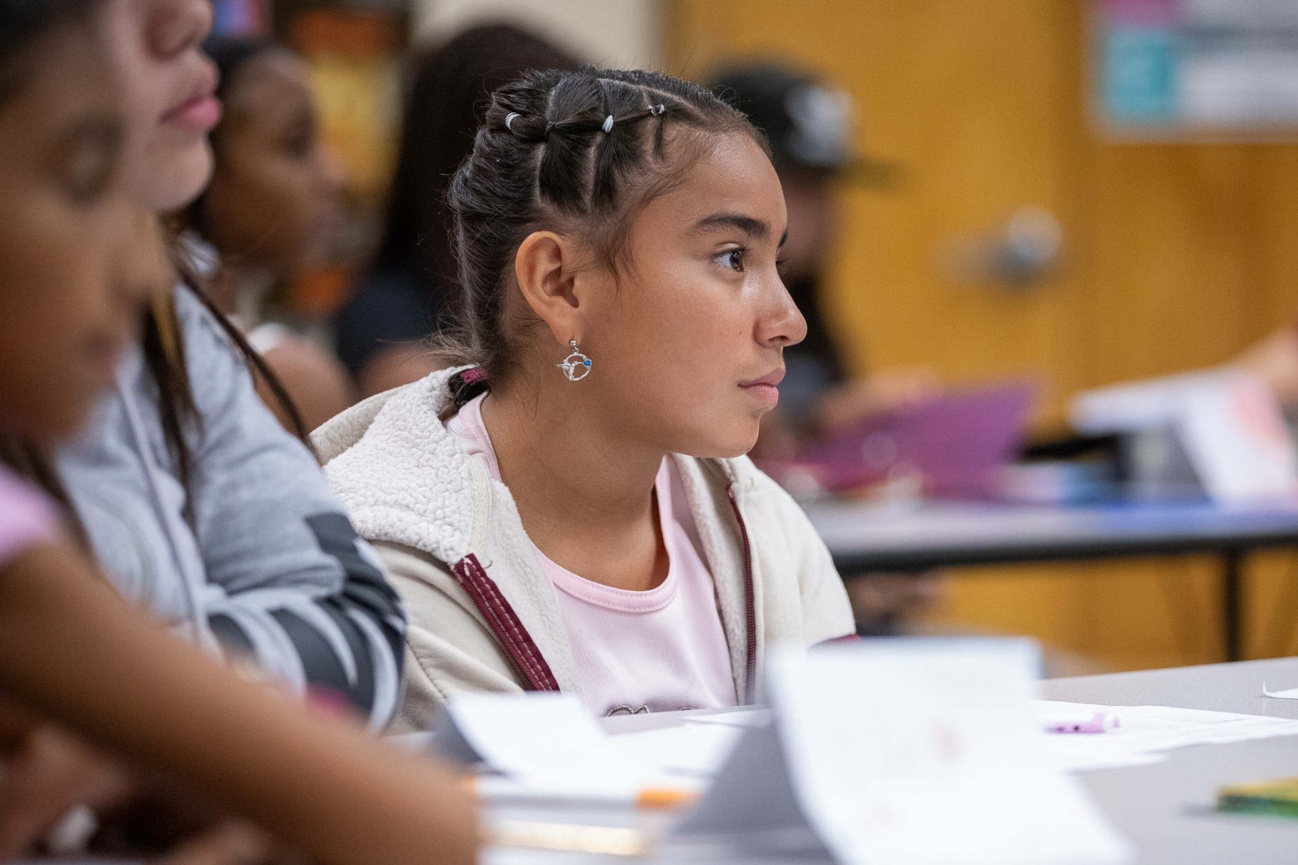 A girl sits at her desk on the first day of school